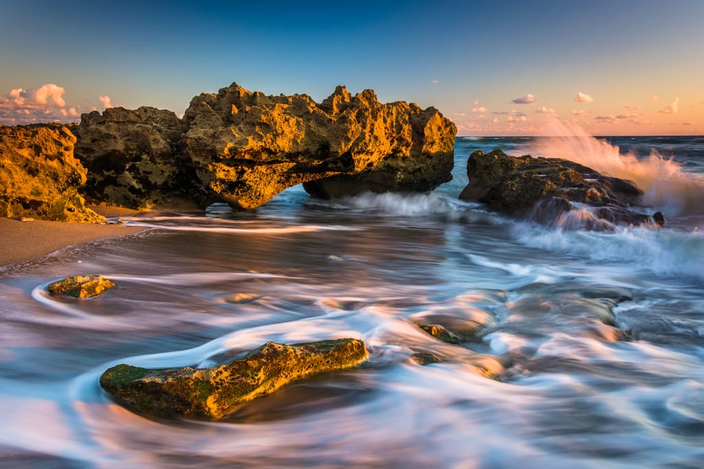 Waves and coral at sunrise in the Atlantic Ocean at Coral Cove Park, on Jupiter Island, Florida.