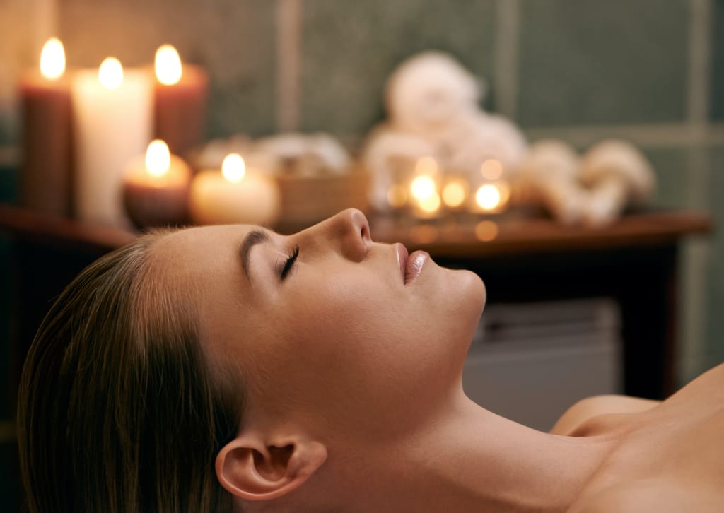 Being pampered from top to toe. A young woman lying with her eyes closed on a massage bed