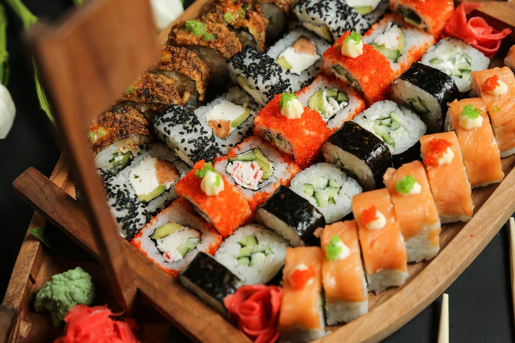 top view mix sushi rolls in a wooden boat-shaped stand